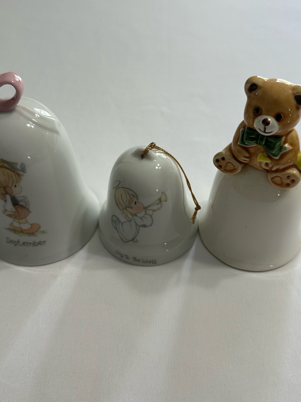 Porcelain Bell Trio with Angel and Teddy Motifs
